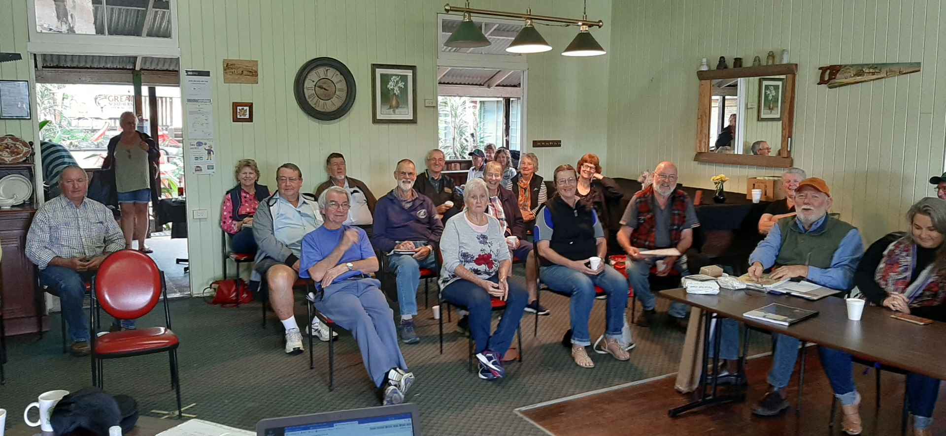 Members of Boyne Burnett Inland Rail Trail sitting, meeting Mungungo Pub