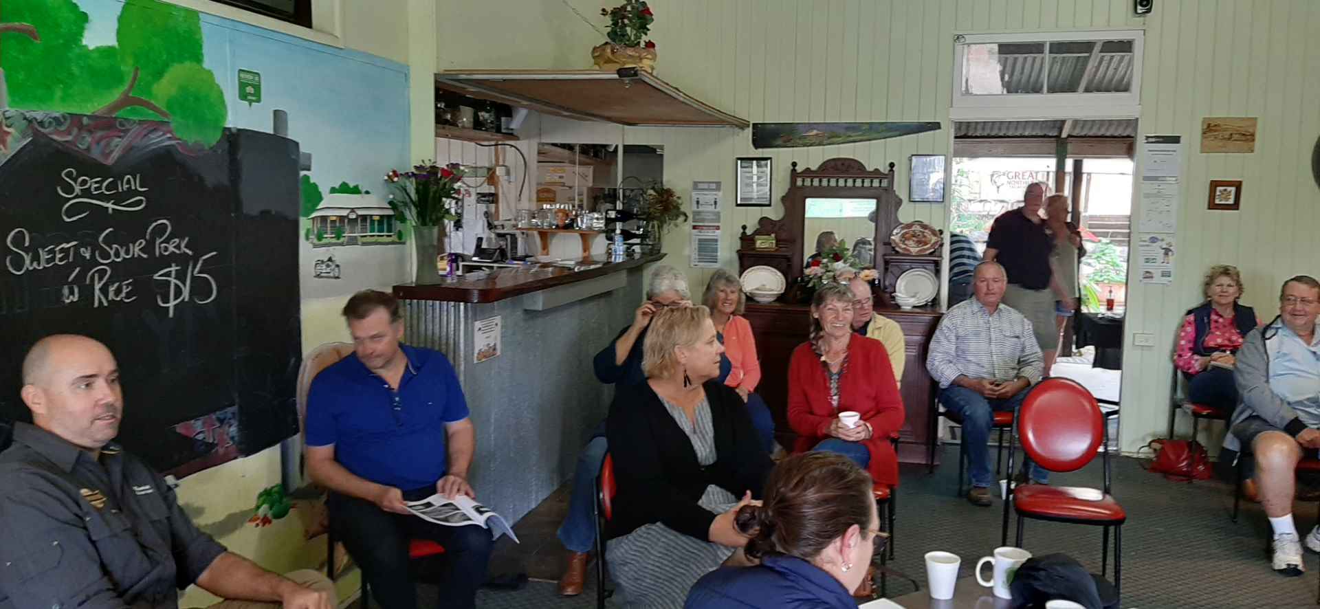 Members of Boyne Burnett Inland Rail Trail sitting, meeting Mungungo Pub